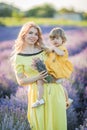 Mother and dauther in lavender field in yellow dress