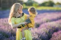 Mother and dauther in lavender field in yellow dress