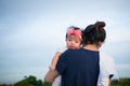 Mother day bonding concept with newborn baby nursing. Mother is holding newborn baby with flower pink headband with blue sky. Focu Royalty Free Stock Photo