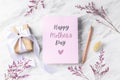 Mother day card with gift box and pink flower on marble table background