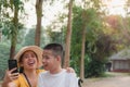 Mother and Disabled child on wheelchair in the city park, They have fun with selfie by smart phone Royalty Free Stock Photo