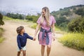 Mother and diverse son walking together holding hands outdoors at a hillside park near Los Angeles California Royalty Free Stock Photo