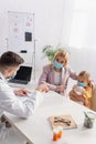 Mother and doctor in medical masks