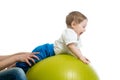 Mother does exercises baby on fitness ball Royalty Free Stock Photo
