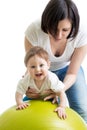 Mother doing gymnastics with baby on fitness ball Royalty Free Stock Photo