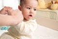 Mother doing massage on her healthy infant baby. Caring Woman Making Gymnastics To little Baby Royalty Free Stock Photo