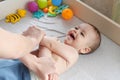 Mother doing massage on her healthy infant baby. Caring Woman Making Gymnastics To little Baby Royalty Free Stock Photo