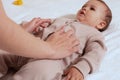 Mother doing massage on her healthy infant baby. Caring Woman Making Gymnastics To little Baby Royalty Free Stock Photo