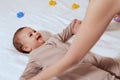 Mother doing massage on her healthy infant baby. Caring Woman Making Gymnastics To little Baby Royalty Free Stock Photo