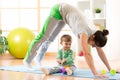 Mother doing yoga or fitness exercises with baby