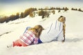 Mother and doughter resting on the snow Royalty Free Stock Photo