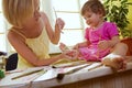 Mother drawing on her daughter