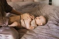 A mother dresses or changes her cute sweet newborn baby Royalty Free Stock Photo