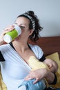 Mother drinks while she breast-feeding