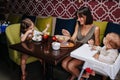 Mother eating in a cafe with her two little children. Happy family moments Royalty Free Stock Photo