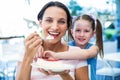 Mother eating a piece of cake with her daughter Royalty Free Stock Photo