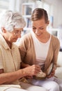 Mother, elderly woman and daughter with pearl necklace, home and conversation in a living room. Family, old lady and Royalty Free Stock Photo