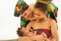 Mother and eldest daughter together carry embrace newborn baby