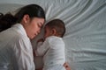 mother embraces the infant baby sleeping together in bed at night Royalty Free Stock Photo