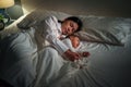 mother embraces the infant baby sleeping together in bed at night Royalty Free Stock Photo