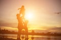 Mother encouraged her son outdoors at sunset, silhouette concept