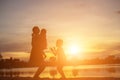 Mother encouraged her son outdoors at sunset, silhouette concept Royalty Free Stock Photo