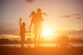 Mother encouraged her son outdoors at sunset, silhouette concept Royalty Free Stock Photo