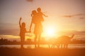 Mother encouraged her son outdoors at sunset, silhouette concept Royalty Free Stock Photo