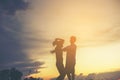 Mother encouraged her son outdoors at sunset, silhouette concept Royalty Free Stock Photo