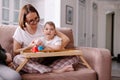 A mother is engaged in a music lesson with her child with cerebral palsy Royalty Free Stock Photo