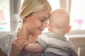 Mother enjoying with her baby boy at home.