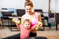 Mother exercising with her baby son at home Royalty Free Stock Photo