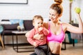 Mother exercising with her baby son at home Royalty Free Stock Photo