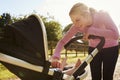 Mother Exercising By Running Whilst Pushing Baby Buggy