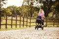 Mother Exercising By Running Whilst Pushing Baby Buggy