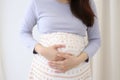 Mother expecting woman holding hand on belly touching pregnancy baby child birth health care life body care healthy pain