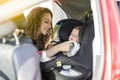 Mother fasten her son in the car seat and putting on his seat belt Royalty Free Stock Photo