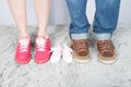 Mother father and baby feet with shoes for family concept foot newborn girl