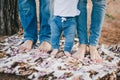 Mother, father and baby feet wearing jeans Royalty Free Stock Photo