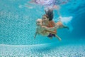 Mother, father with baby swimming, diving underwater in pool Royalty Free Stock Photo