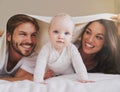 Mother, father and baby under blanket on bed for love, care and quality time together. Portrait of playful child, happy Royalty Free Stock Photo