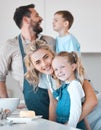 Mother and father baking with their children. Siblings baking with their parents in the kitchen. Portrait of a mother Royalty Free Stock Photo