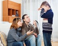 Mother and father with belt berating teenager Royalty Free Stock Photo