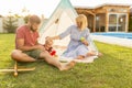 Mother and father camping with their baby boy in the backyard by the swimming pool Royalty Free Stock Photo