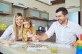 Mother, father and child draw together at the table. Royalty Free Stock Photo