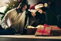 Mother, father and child with gift for Christmas in celebration of a Christian winter holiday as a happy family. Night Royalty Free Stock Photo