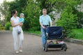 Mother, father and child go with a baby stroller on the way