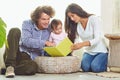 Mother, father and child are reading a book at home Royalty Free Stock Photo