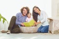 Mother, father and child are reading a book at home Royalty Free Stock Photo