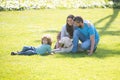 Mother father and child son with pet dog having fun outdoors at summer park. Royalty Free Stock Photo